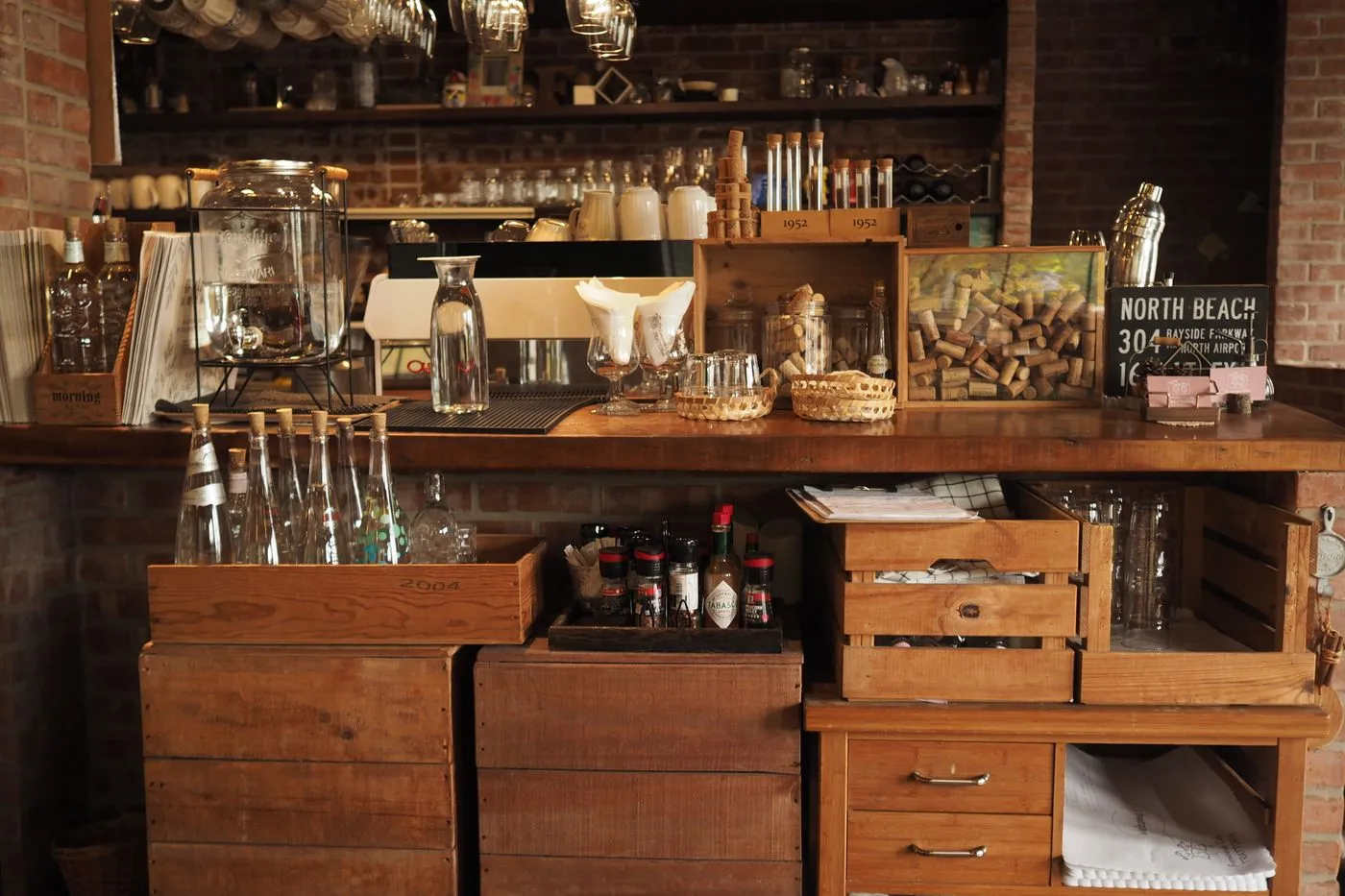 Rustic wooden bar counter with crates and glassware