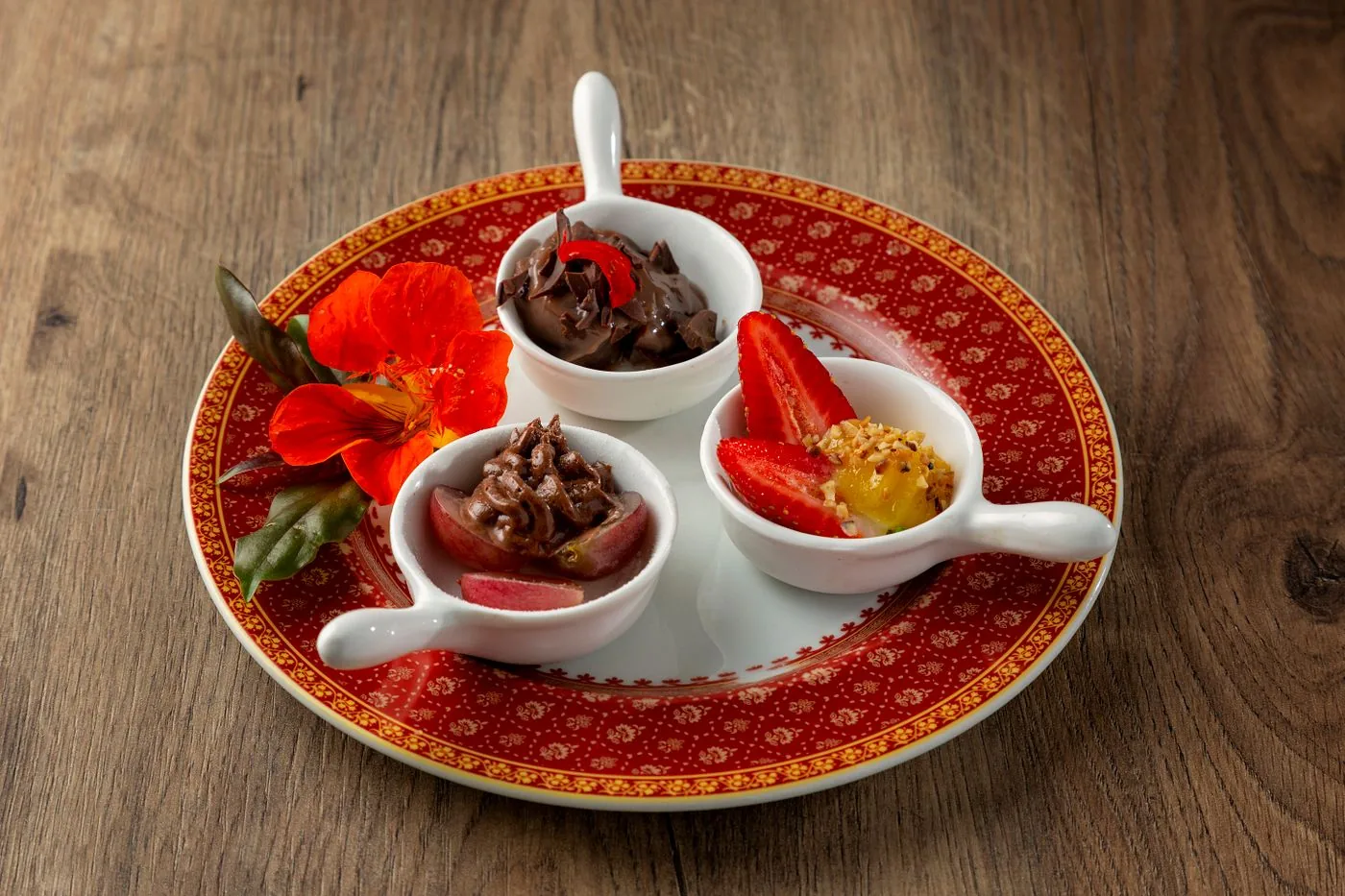 Elegant dessert tasting spoons garnished with fruit and flowers